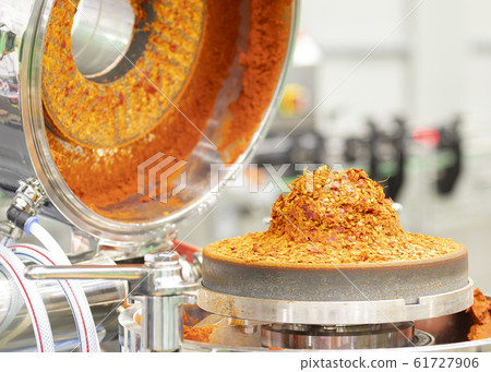 Red ground chili in chili paste grinder machine Red ground chili in chili paste grinder machine 61727906