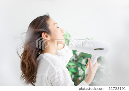 一個女人用吹風機 61728191