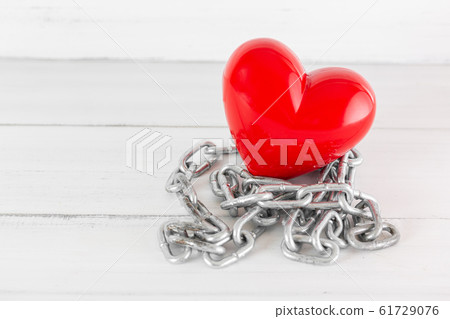 Red Heart with Chain on white wood background with Red Heart with Chain on white wood background with 61729076