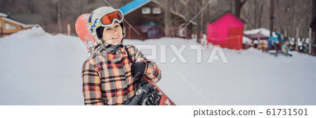 Woman snowboarder on a sunny winter day at a ski resort BANNER, LONG FORMAT 61731501