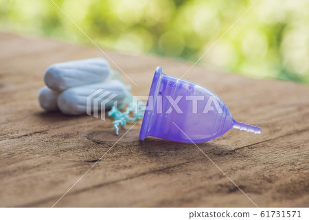 Different types of feminine hygiene products - menstrual cup and tampons Different types of feminine hygiene products - menstrual cup and tampons 61731571