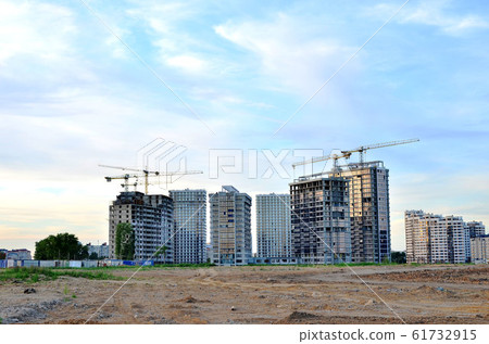 Jib construction tower crane and new residential buildings at a construction site Jib construction tower crane and new residential buildings at a construction site 61732915