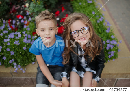 young happy boy and girl together outside young happy boy and girl together outside 61734277