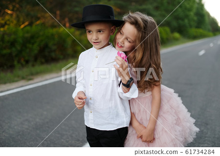 young happy boy and girl together outside young happy boy and girl together outside 61734284