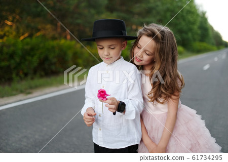 young happy boy and girl together outside young happy boy and girl together outside 61734295