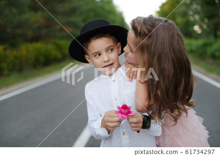 young happy boy and girl together outside young happy boy and girl together outside 61734297