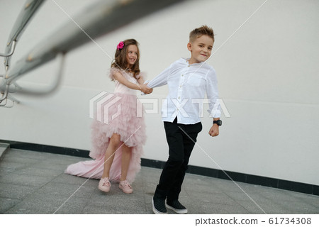 young happy boy and girl together outside young happy boy and girl together outside 61734308