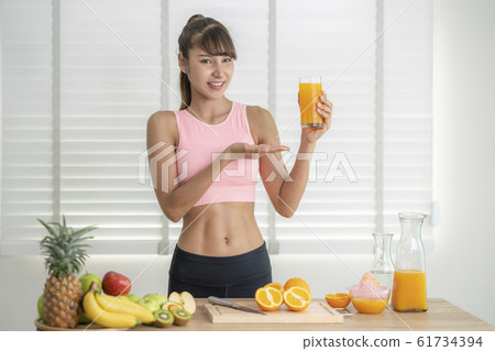 Asian girl make an orange juice by hand at home 61734394