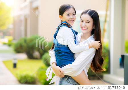 Mother and  her daugter play togather in front of 61735040
