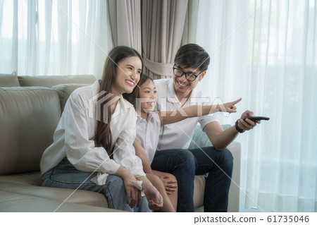 Asian family see the movie togather on sofa in Asian family see the movie togather on sofa in 61735046