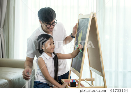Asian teacher teach he student to draw a flower in 61735164