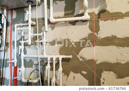 Worker is working on installing pipes for floor Worker is working on installing pipes for floor 61736766