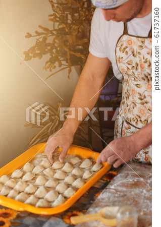 Handsome young man making small circles from raw 61737160