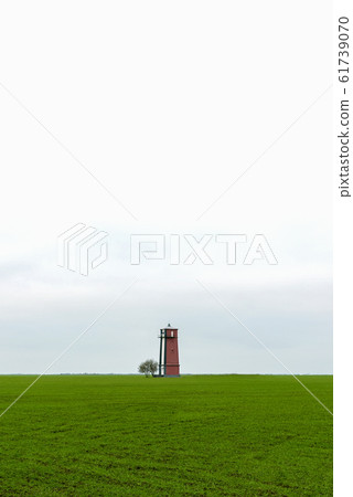 Old lighthouse with red stripes. Scenic landscape Old lighthouse with red stripes. Scenic landscape 61739070
