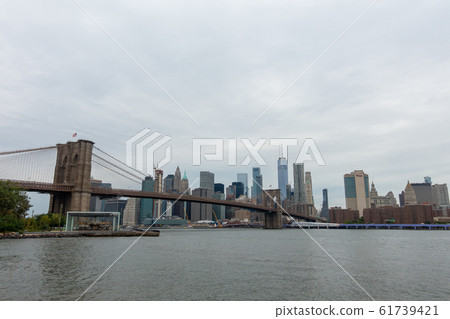 People walking in Brooklyn bridge at day time 61739421