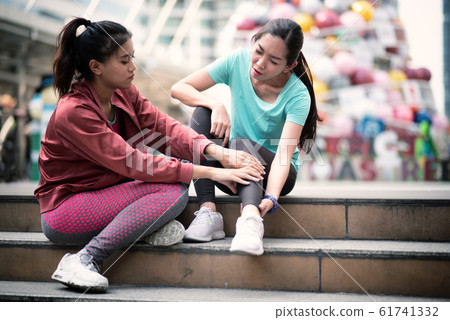 Asian woman runner with ankle injury. 61741332