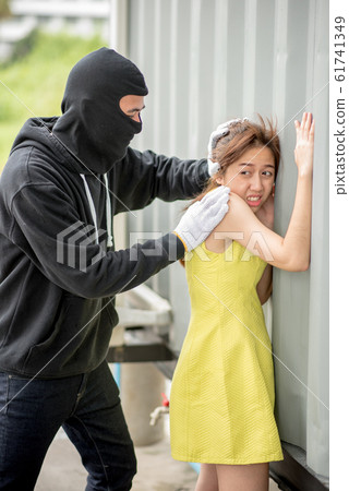 Bandit wear black mask with a knife attacks a girl 61741349