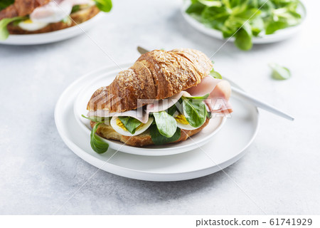 Fresh croissant with green salad Fresh croissant with green salad 61741929