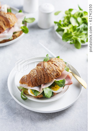 Fresh croissant with green salad 61741930