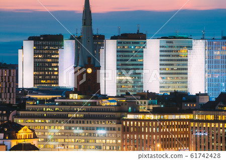 Stockholm, Sweden. Close View Of St. Clara Or Saint Klara Church And Houses In Twilight Dusk Lights. Evening Night Lighting Stockholm, Sweden. Close View Of St. Clara Or Saint Klara Church And Houses In Twilight Dusk Lights. Evening Night Lighting 61742428