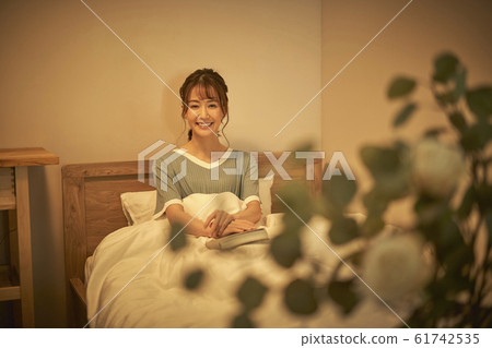 A woman relaxing in a room A woman relaxing in a room 61742535
