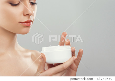 Beauty Concept. woman holds a moisturizer in her 61742659