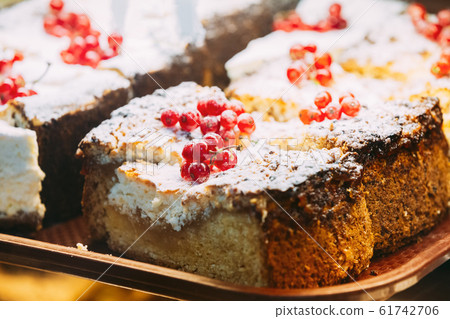 Fresh Sweet Cakes With Red Currant Berries In Pastry Shop Glass Display. Fresh Sweet Cakes With Red Currant Berries In Pastry Shop Glass Display. 61742706