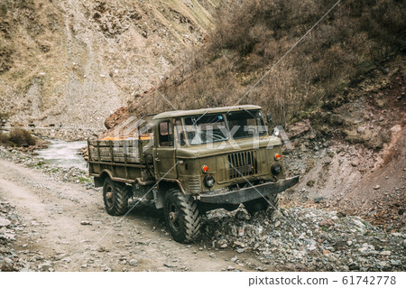 Old Soviet Russian Medium-duty Truck On Mountains Country Road. Truso Gorge, Kazbegi District, Mtskheta-Mtianeti Region, Georgia 61742778