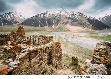 Fortress On Mountain Background Near Karatkau Village, Kazbegi District, Mtskheta-Mtianeti Region, Georgia. Spring, Summer Season. Truso Gorge. 61742800