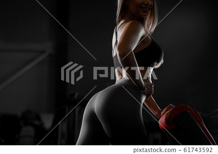 pretty caucasian fitness woman pumping up muscles 61743592