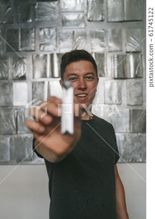 Concept of bad guy with top secret information. Man holding USB momory stick 61745122