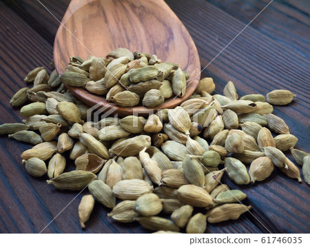 Green cardamom pods on the dark wooden textured 61746035