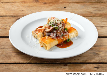 Thin pancakes stuffed with beef and mushrooms 61746067