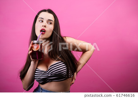 woman drinking lemonade or iced tea from jar 61746616