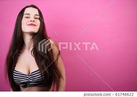 Happy smiling beautiful woman on pink background 61746622