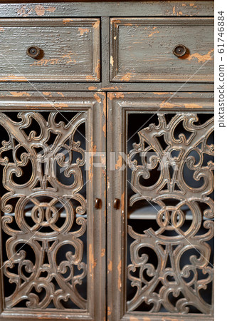 Old carved wooden cupboard doors.The peeled paint. 61746884