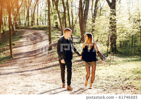 Beautiful couple spend time in a spring park 61746885