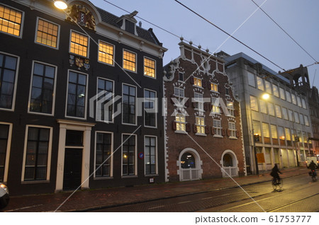People commuting by bicycle in Amsterdam, the Netherlands 61753777