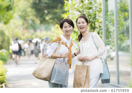 Mother and daughter after shopping Mother and daughter after shopping 61755959