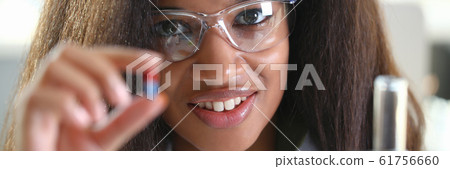 Female medicine doctor hand hold jar of pills 61756660