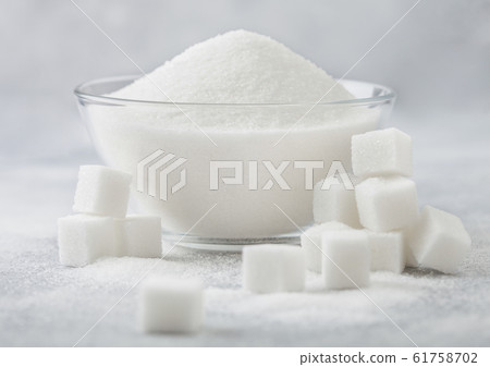 Glass bowl of natural white refined sugar with Glass bowl of natural white refined sugar with 61758702