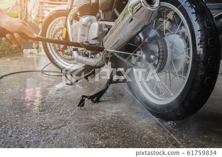 people wash cleaning motorcycle at home people wash cleaning motorcycle at home 61759834