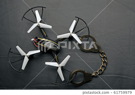 quadcopter handcuffs dark leather background quadcopter handcuffs dark leather background 61759979