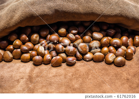 Roasted Chestnuts on brown towel Roasted Chestnuts on brown towel 61762016