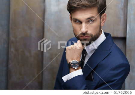 indoor photo of young handsome stylish businessman wearing suit 61762066