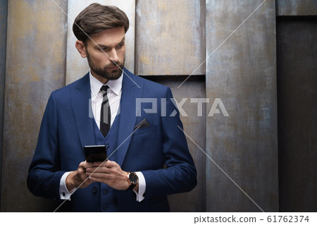 indoor photo of young handsome stylish businessman wearing suit 61762374