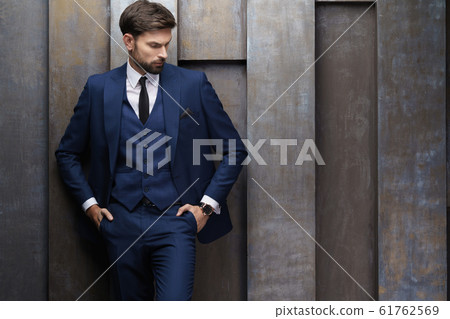 indoor photo of young handsome stylish businessman wearing suit 61762569
