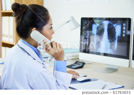 Doctor Ringing Up Her Colleague 61763655