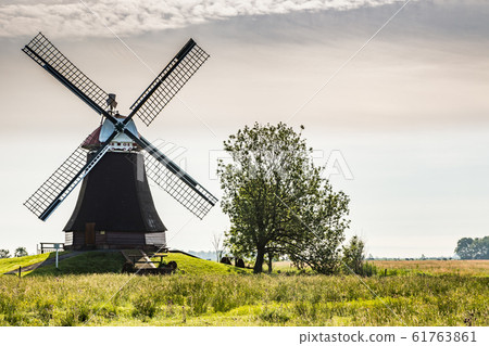 Windmill Wynhamster Kolk in typical East Frisian landscape, Lower Saxony, Germany 61763861