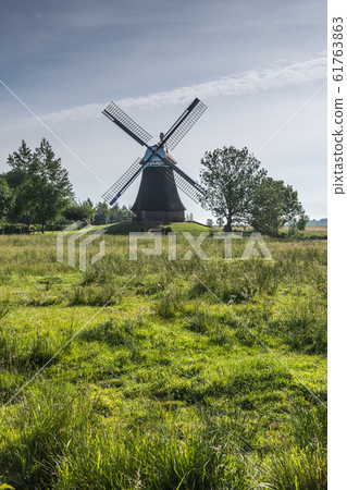 Windmill Wynhamster Kolk in typical East Frisian landscape, Lower Saxony, Germany  61763863
